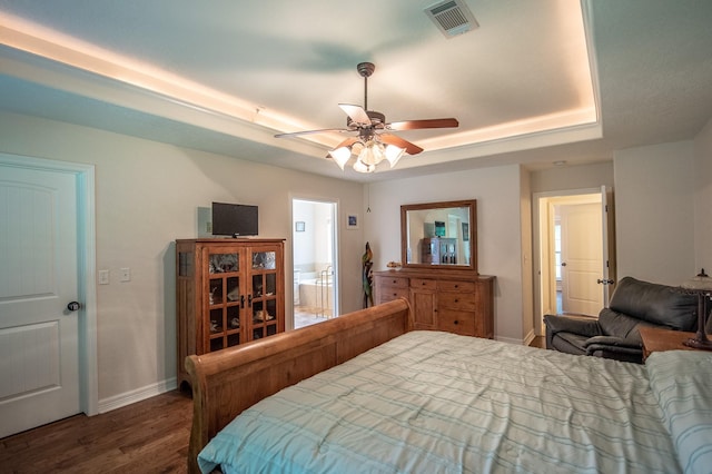 bedroom with baseboards, a ceiling fan, wood finished floors, and visible vents