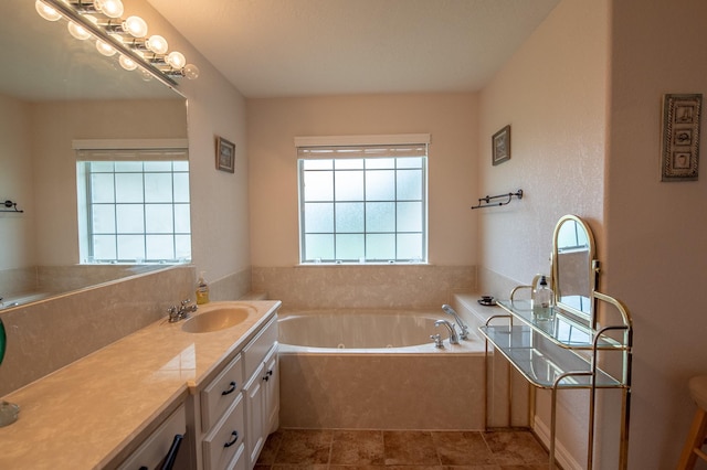full bath with vanity and a tub with jets