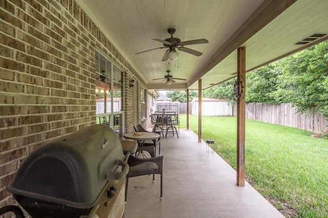 view of patio / terrace with a fenced backyard, a ceiling fan, outdoor dining area, and a grill