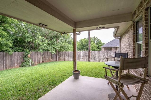view of yard with a fenced backyard, a patio area, and visible vents