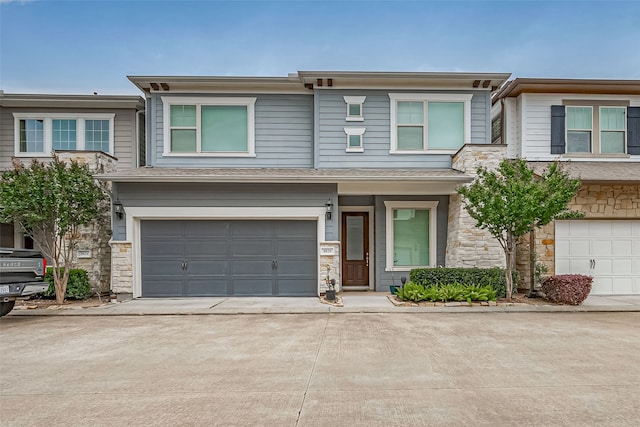 8820 Ashbloom Ln, Houston, TX 77080 - townhome / multi-family property with stone siding, concrete driveway, and a garage