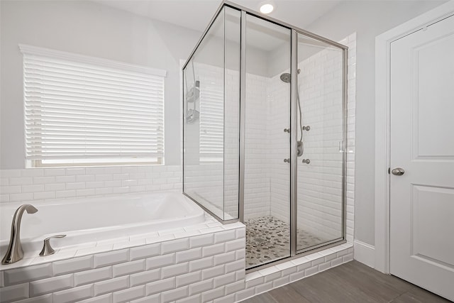 8820 Ashbloom Ln, Houston, TX 77080 - bathroom featuring a garden tub, a shower stall, and wood finished floors