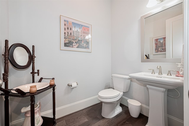 8820 Ashbloom Ln, Houston, TX 77080 - half bathroom with baseboards, wood finished floors, and toilet