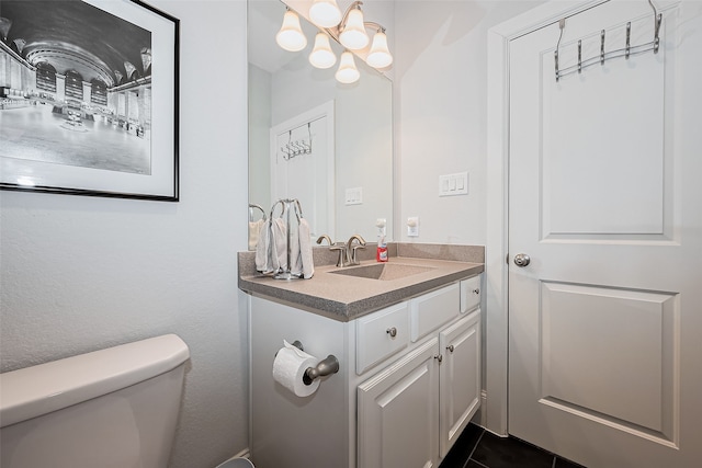 8820 Ashbloom Ln, Houston, TX 77080 - bathroom featuring toilet, vanity, a chandelier, and tile patterned floors