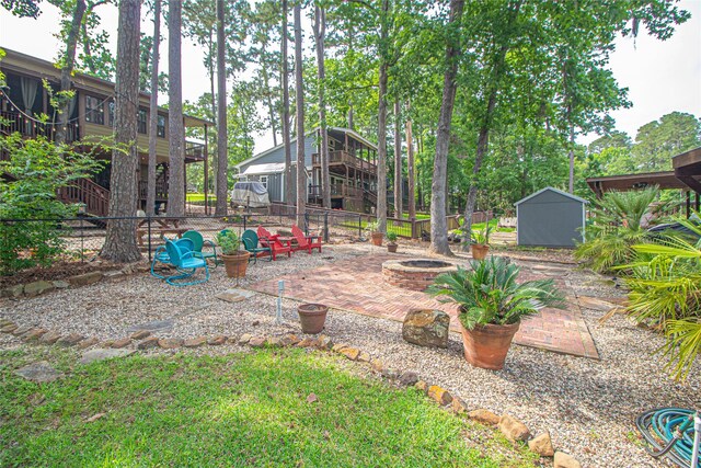 70 Lower Cove Dr, Point Blank, TX 77364 - fenced backyard with a fire pit and a patio area