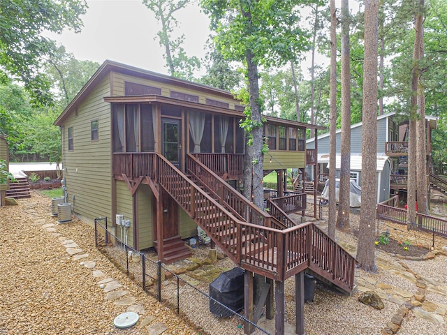 70 Lower Cove Dr, Point Blank, TX 77364 - rear view of property with a sunroom, stairs, a fenced backyard, and cooling unit