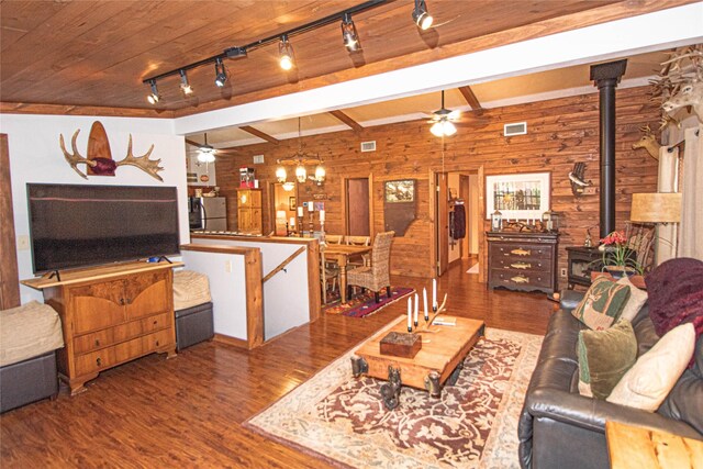 70 Lower Cove Dr, Point Blank, TX 77364 - living area with ceiling fan, wood finished floors, a wood stove, wood walls, and beam ceiling