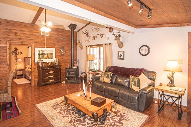 70 Lower Cove Dr, Point Blank, TX 77364 - living area featuring a wood stove, a ceiling fan, wooden walls, wood finished floors, and wood ceiling