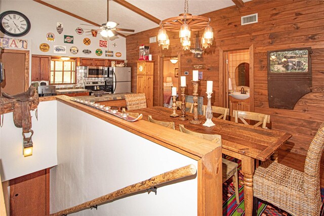 70 Lower Cove Dr, Point Blank, TX 77364 - dining room with wood walls, vaulted ceiling, a ceiling fan, and a chandelier