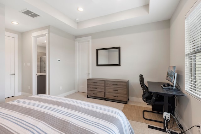 bedroom featuring light colored carpet, visible vents, multiple windows, and baseboards
