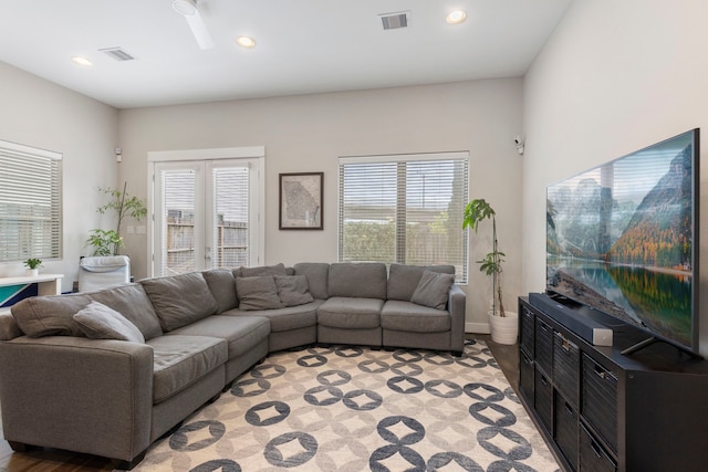 living room with a wealth of natural light, visible vents, and recessed lighting