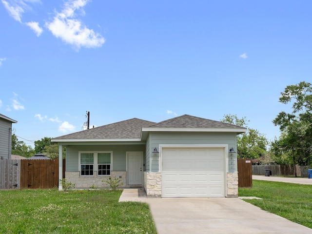 ranch-style home featuring a garage, a front yard, concrete driveway, and stone siding