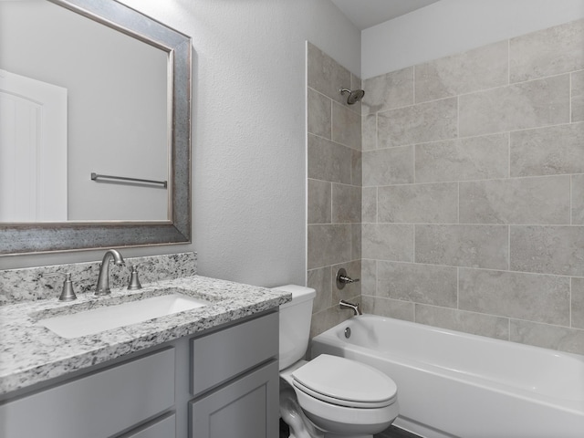 full bathroom with vanity, toilet, a textured wall, and shower / bath combination