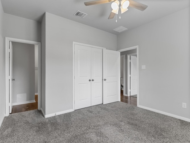 unfurnished bedroom with carpet, visible vents, baseboards, and a closet