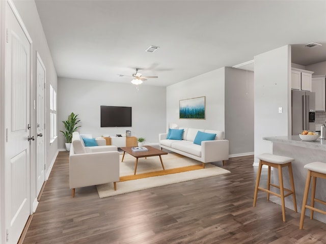 2921 4th St, Bay City, TX 77414 - living area featuring dark wood finished floors, baseboards, and ceiling fan