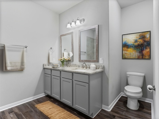 2921 4th St, Bay City, TX 77414 - bathroom with double vanity, wood finished floors, toilet, and baseboards