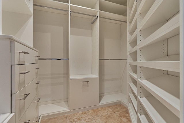 spacious closet with light tile patterned flooring