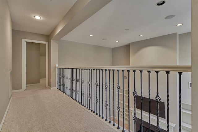 hallway with baseboards, recessed lighting, and carpet floors
