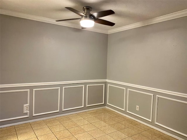 unfurnished room featuring light tile patterned floors, a ceiling fan, crown molding, and a decorative wall