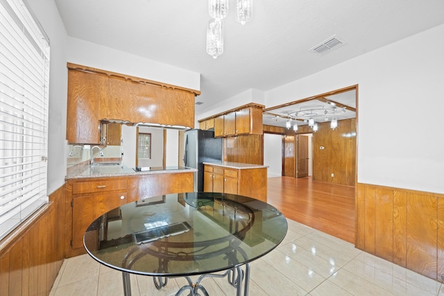 7718 Pella Dr, Houston, TX 77036 - dining room featuring light tile patterned flooring, wooden walls, a wainscoted wall, and visible vents