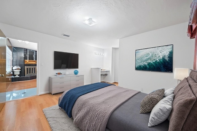 7718 Pella Dr, Houston, TX 77036 - bedroom featuring visible vents and light wood-type flooring
