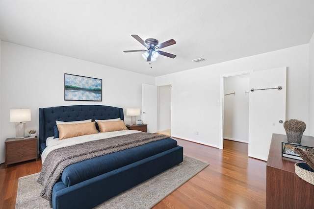 7718 Pella Dr, Houston, TX 77036 - bedroom featuring baseboards, visible vents, wood finished floors, and ceiling fan
