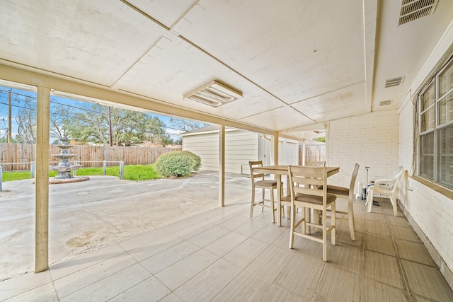 7718 Pella Dr, Houston, TX 77036 - view of patio featuring visible vents, a fenced backyard, an outdoor structure, and outdoor dining area