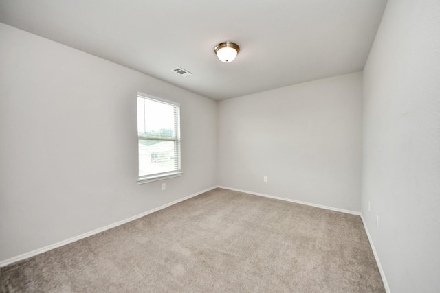 unfurnished room with baseboards, visible vents, and carpet flooring