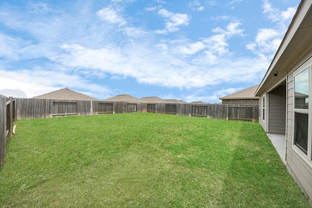 view of yard with a fenced backyard