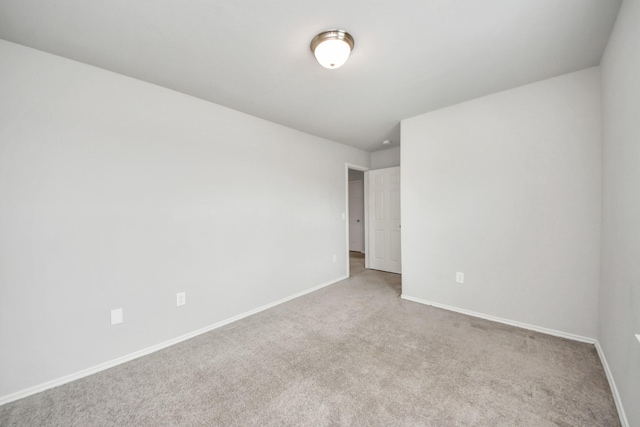 unfurnished room with carpet and baseboards