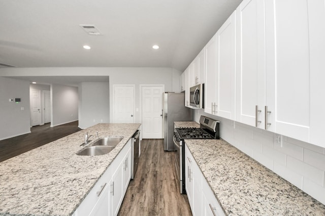 kitchen with visible vents, stainless steel appliances, dark wood finished floors, and a sink