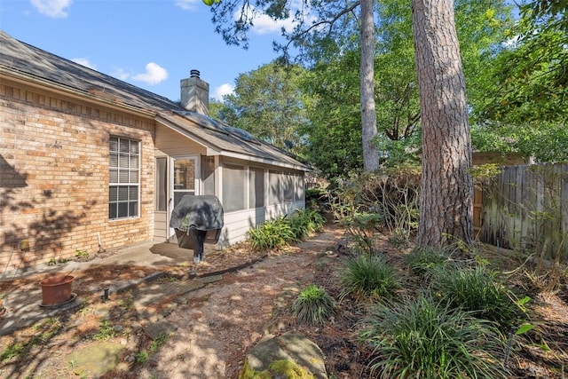 view of yard featuring a sunroom and fence