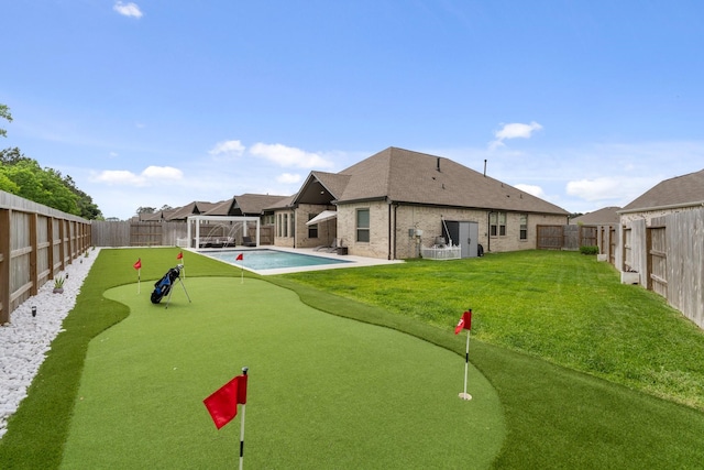 view of community with a fenced backyard, a swimming pool, and a yard