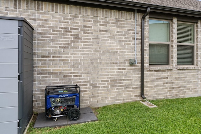 exterior details featuring a downspout, brick siding, and gutters
