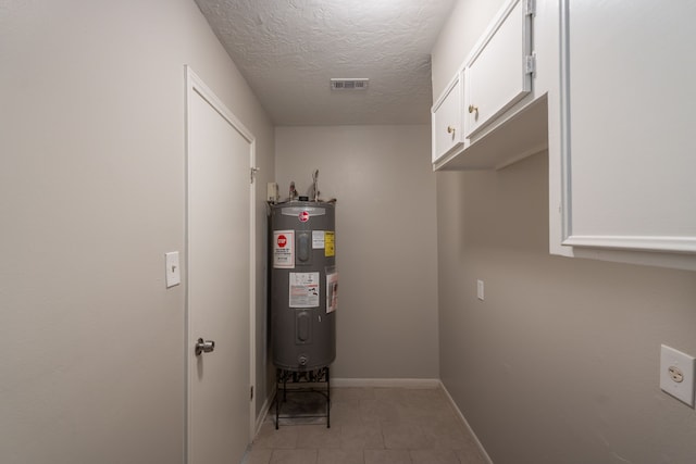utilities featuring visible vents and electric water heater