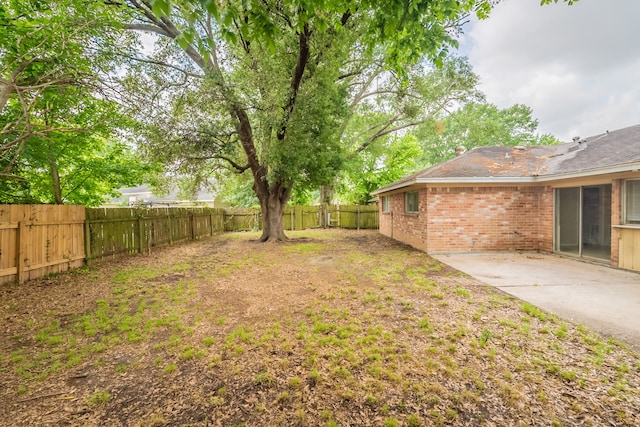 view of yard with a fenced backyard and a patio area