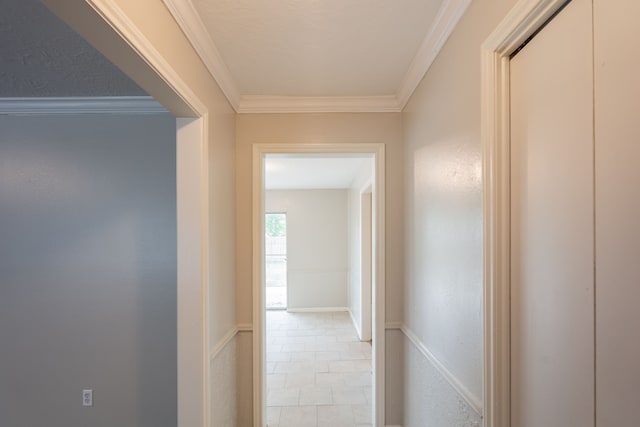 hallway featuring crown molding and tile patterned flooring
