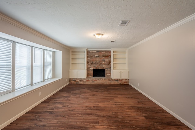 unfurnished living room with a textured ceiling, visible vents, baseboards, dark wood-style flooring, and a brick fireplace