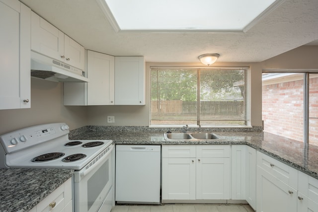 kitchen with a sink, white cabinets, under cabinet range hood, and white appliances