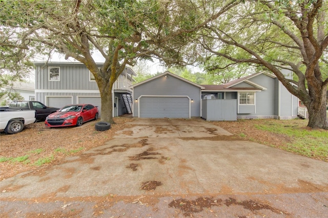 view of front of home with board and batten siding, concrete driveway, and an attached garage