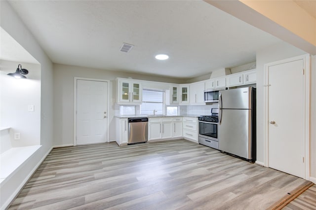 kitchen featuring visible vents, white cabinetry, and stainless steel appliances