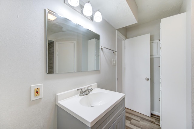bathroom featuring vanity and wood finished floors