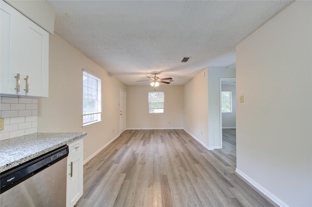 112 Begonia Ln, Highlands, TX 77562 - kitchen with stainless steel dishwasher, a textured ceiling, white cabinetry, light wood-style floors, and ceiling fan