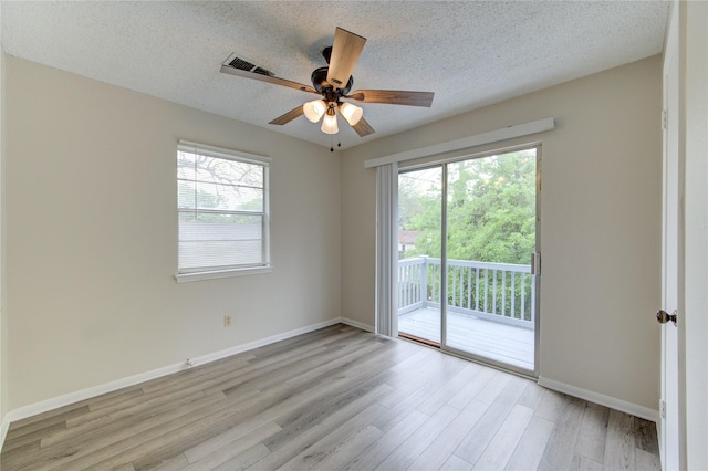 112 Begonia Ln, Highlands, TX 77562 - empty room featuring plenty of natural light, light wood-style flooring, ceiling fan, a textured ceiling, and baseboards