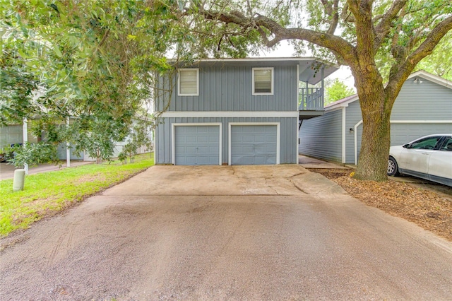 112 Begonia Ln, Highlands, TX 77562 - view of front of property with a balcony, an attached garage, and concrete driveway