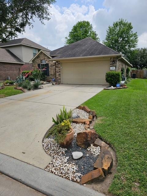1318 Evermore Manor Ln, Houston, TX 77073 - view of front of property featuring an attached garage, driveway, a front yard, and stone siding