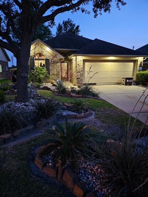 1318 Evermore Manor Ln, Houston, TX 77073 - view of front of property with an attached garage, driveway, and stone siding