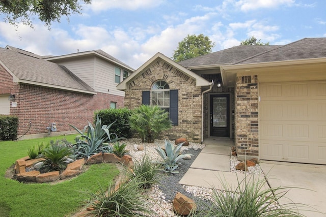1318 Evermore Manor Ln, Houston, TX 77073 - view of front facade featuring an attached garage, driveway, roof with shingles, and stone siding