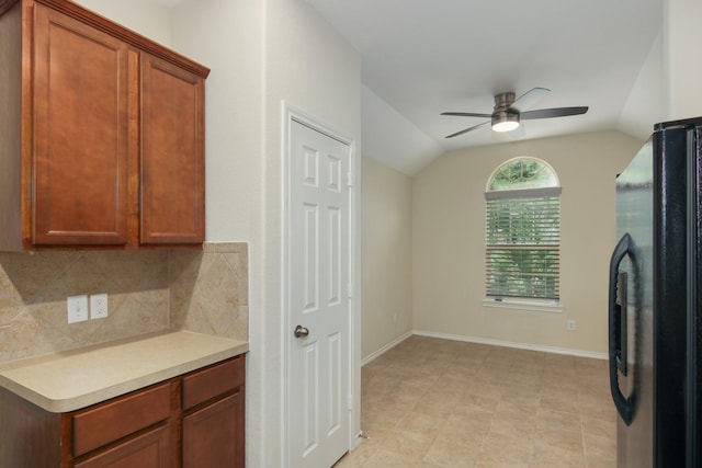 1318 Evermore Manor Ln, Houston, TX 77073 - kitchen with freestanding refrigerator, ceiling fan, vaulted ceiling, decorative backsplash, and light countertops