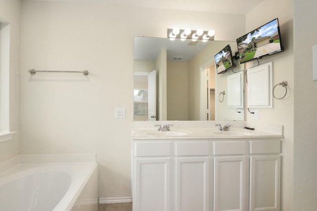 1318 Evermore Manor Ln, Houston, TX 77073 - bathroom featuring a bath, double vanity, and baseboards